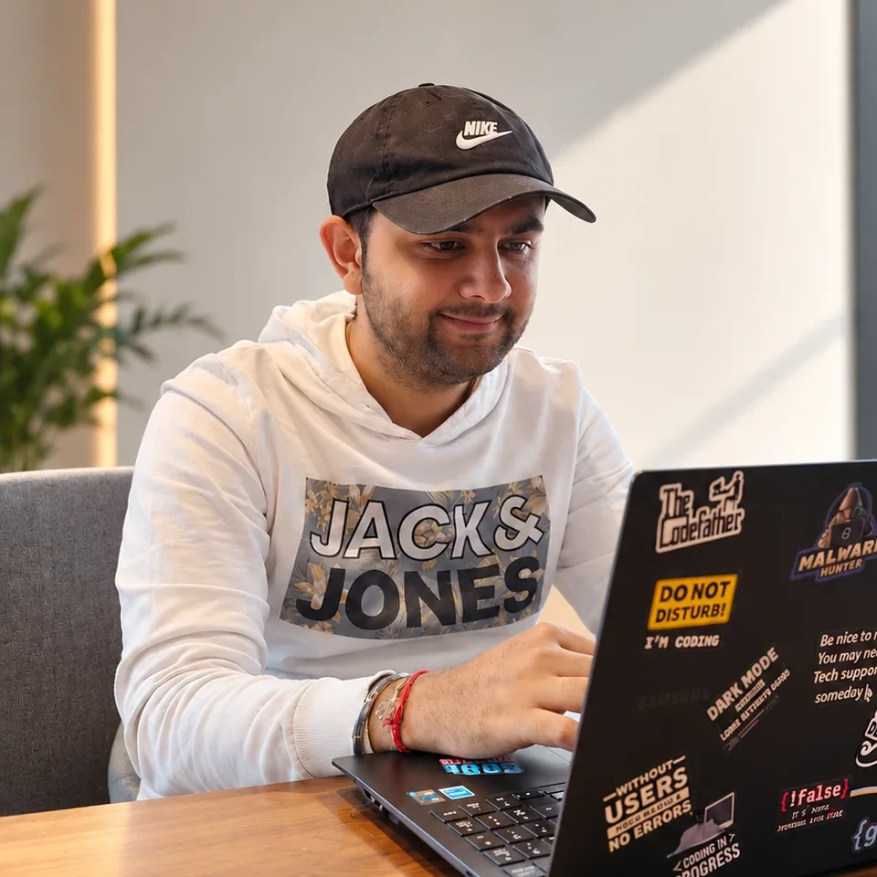 Meet, working at a sticker-covered laptop